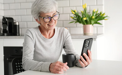 Cheerful Elderly Lady Video Calls Using A Messaging App