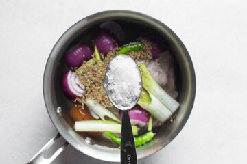 Overhead view of maldon salt in a teaspoon, top view of a teaspoon of sea salt