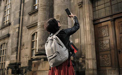 Attractive Female Tourist Walks With Germany Flag In Dresden'S Historical Center, Taking Pictures...