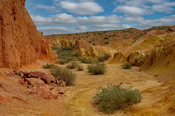 Northern Kyrgyzstan. Picturesque views of the famous Skazka Canyon (, the clay mountain peaks of which have bright colors from yellow to red-brown.