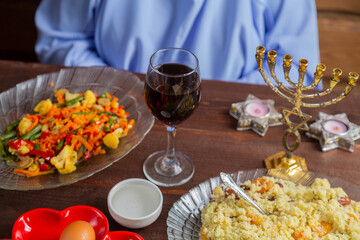 The table is festively set with matzo and kearah for the Jewish holiday of Pesach Seder