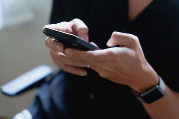 Close up male using his smartphone scroll through social media