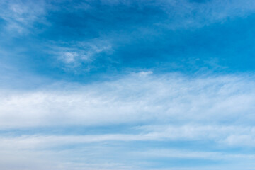 Obraz premium Blue sky background with a white clouds.