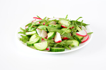 salad of cucumber, radish and arugula isolated on white   