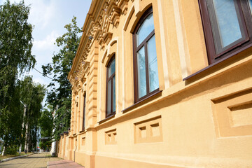 a building facade with windows in the street 