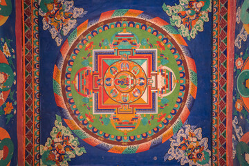 A detailed view of a vibrant tibetan mandala painting displayed on a Monastery wall in Zanskar