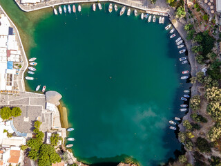 Aerial top view by drone of Voulismeni Lake in Agios Nikolaos city. Greece, Crete.