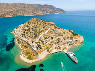 View of the fortress on the Spinalonga island with calm sea. Old venetian fortress and former leper...