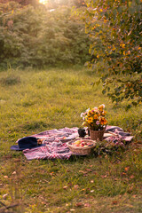romantic fall picnic with flowers, lanterns for a cozy date in a serene natural setting outdoor at countryside