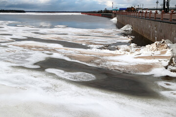 Spring flood, river with remnants of ice, melting ice, landscape river ice spring, thawed dangerous ice.