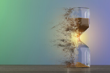 Hourglass dissolving on table against color background. Fleeting time