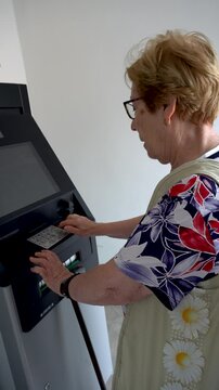Senior woman using the ATM