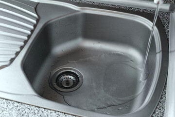 Kitchen sink close up.
Stainless steal kitchen sink with water drops. 