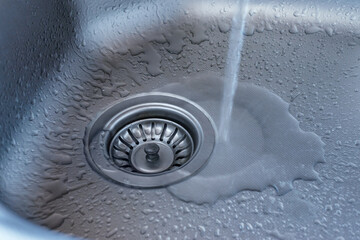 Kitchen sink close up.
Stainless steal kitchen sink with water drops. 
