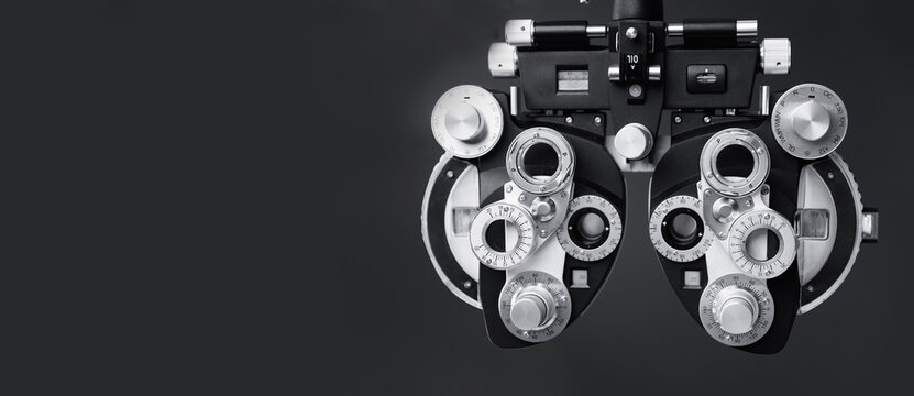 Autorefractor for diagnostic eye, phoropter slit lamp optical examination tool. Clinic dark background banner