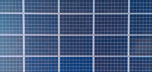 aerial view of solar panels on solar farm during a sunny day. modern photovoltaic solar battery panels. Renewable energy concept