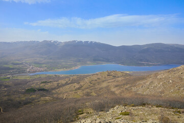 Reservoir in the Lozoya valley next to the town of Pinilla and the mountains of the Guadarrama National Park, in Madrid, Spain