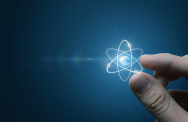 Fingers touching an atom.