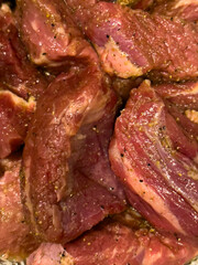 A close up of chucks of beef in a pan