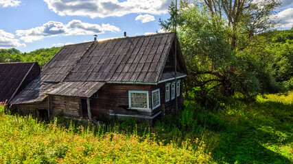 Old wooden house in the village on a sunny summer day