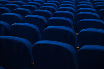 Blue empty seats in the audience prepared for the participants of the conference or presentation