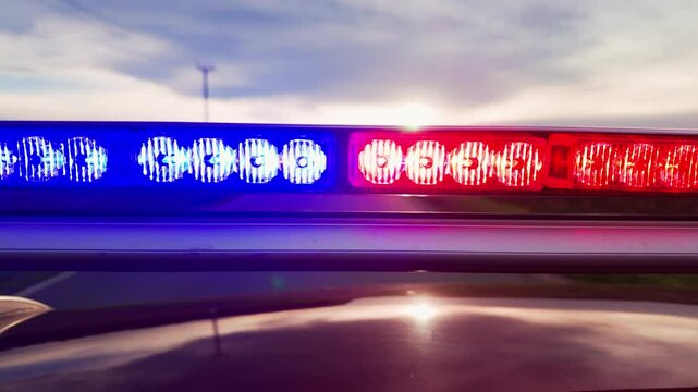 Police patrol car with flashing special signal rushes along road.