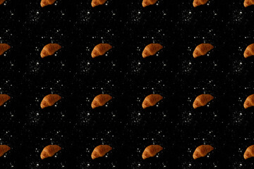 Pattern of baked croissants with a black background. Delicious pastries