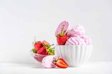 pink strawberry marshmallows in a beautiful white plate on a white background
