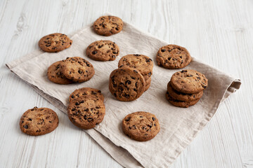 Homemade Gooey Chocolate Chip Cookies on a white wooden background, side view.