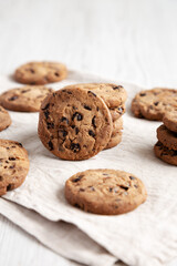 Homemade Gooey Chocolate Chip Cookies on a white wooden background, low angle view.