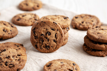 Homemade Gooey Chocolate Chip Cookies on a white wooden background, low angle view.
