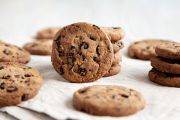 Homemade Gooey Chocolate Chip Cookies on a white wooden background, low angle view. Close-up.