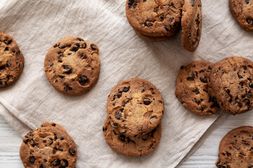 Homemade Gooey Chocolate Chip Cookies on a white wooden background, top view.