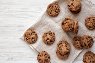 Homemade Gooey Chocolate Chip Cookies on a white wooden background, top view. Copy space.