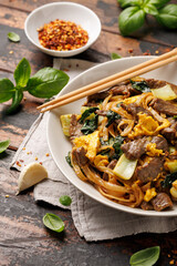 Thai Pad See Ew with beef, eggs, vegetables and rice noodles.