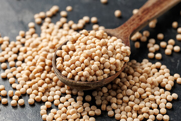 Giant or Pearl Wholewheat Couscous in a wooden spoon