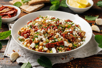 Pearl Couscous salad with sun dried tomatoes, chickpeas and feta cheese. healthy food