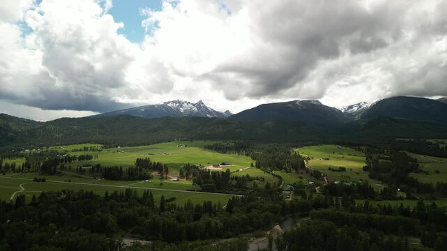 Aerial of homes in beautiful mountain valley in Bitterroot range near Missoula Montana in summer