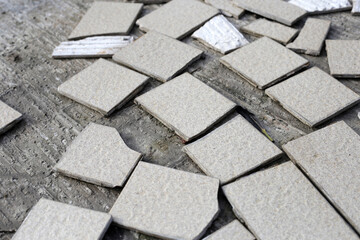 Cracked brown tiles on cement floor