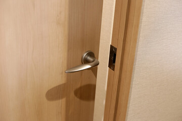 Wooden door open, metallic handle