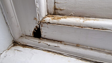 Close up of a damage to an old wooden framed window