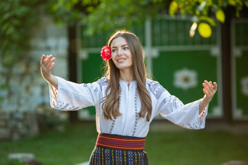 Beautiful girl in traditional Romanian folk costume with embroidery. Woman traditional blouse. Romanian folklore