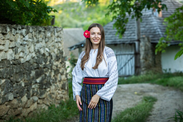 Beautiful girl in traditional Romanian folk costume with embroidery. Woman traditional blouse....