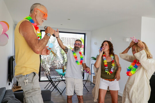 Vibrant indoor gathering with mature friends enjoying a playful party