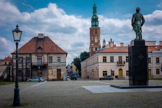 RADOM, POLAND - July 26, 2021:
Old town market square. The monument of Legions Act, a tower of medieval St John's Church in background. 

