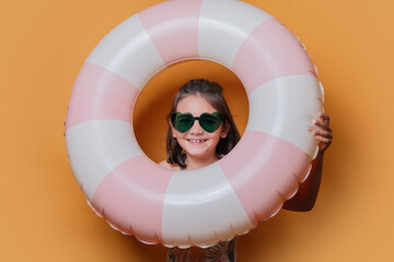 Young girl with swimming ring in summer themed photo shoot