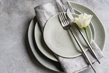 Elegant table setting with godetia flower and rustic tableware