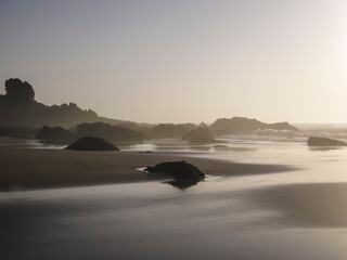 Tranquil coast with stunning rock formations under a beautiful sunset, creating a calm atmosphere. Sepia look.