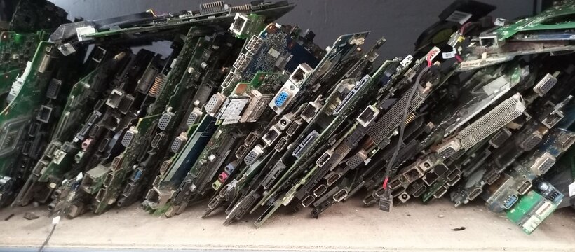 broken laptop motherboard arranged at an angle on a shelf