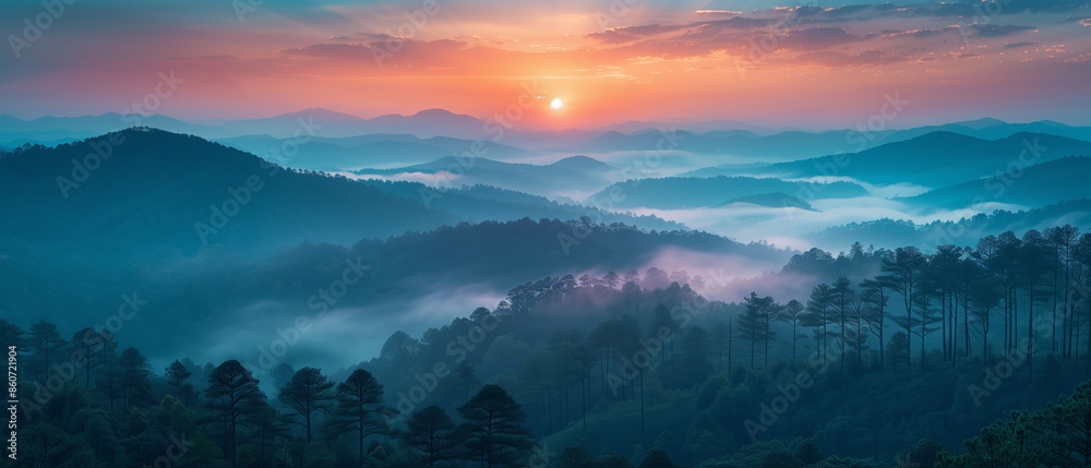 Poster a beautiful mountain range with a sun setting in the background. the sky is a mix of blue and orange